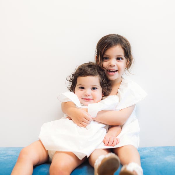 two little girls sitting on bench